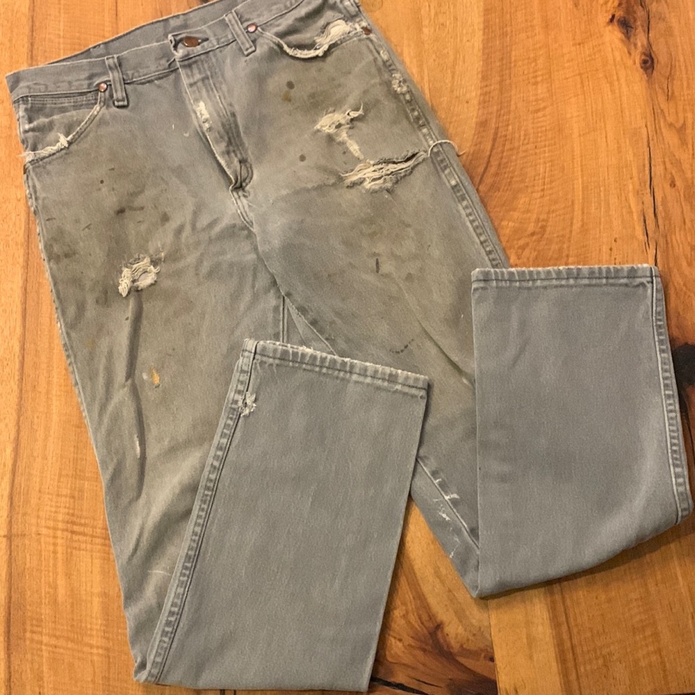 Distressed destroyed workwear wrangler jeans